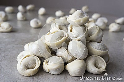 Dumplings taken out of the freezer and scattered on the table Stock Photo