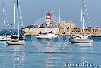 Dun Laoghaire harbour with its Victorian lighthouse on the coast of County Wicklow in Ireland on a calm spring morning Stock Photo