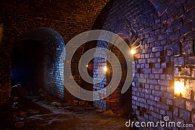Dungeon under the old german fortress illuminated by lantern and candles Stock Photo
