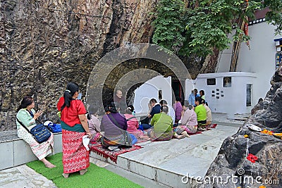Pilgrims praying at entrance to Dungeshwari Cave, where Gautama Buddha is said to have spent 6-7 years in extreme asceticism Editorial Stock Photo