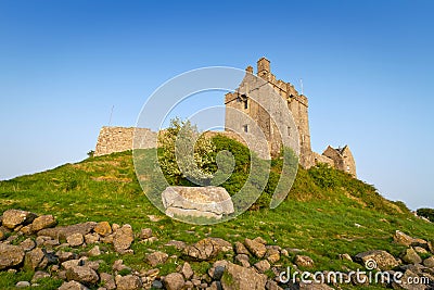 Dunguaire castle on green hill Stock Photo