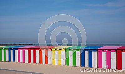 Dunkerque, France: Brightly colored striped beach huts on the sea front at Malo-Les-Bains beach in Dunkirk Editorial Stock Photo