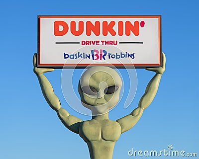 Dunkin Donuts alien holding sign Editorial Stock Photo