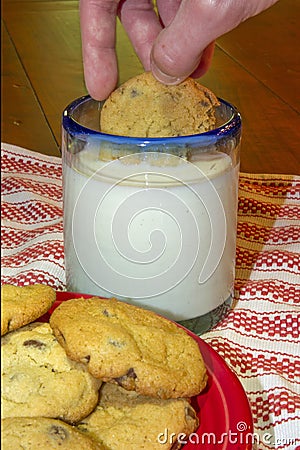 Dunking cookie in milk Stock Photo