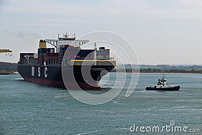 DUNKIRK/FRANCE - April 17, 2014: Tugboat towing the MSC Capella Editorial Stock Photo