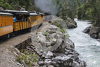 Durango and Silverton Narrow Gauge Railroad Steam Engine travels along Animas River, Colorado, USA Editorial Stock Photo