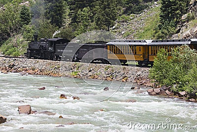 The Durango and Silverton Narrow Gauge Railroad Steam Engine travels along Animas River, Colorado, USA Editorial Stock Photo