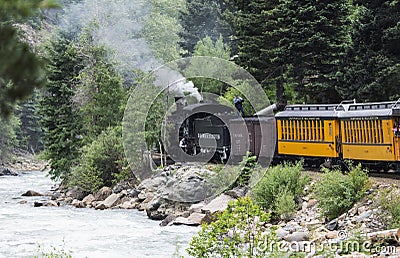 The Durango and Silverton Narrow Gauge Railroad Steam Engine travels along Animas River, Colorado, USA Editorial Stock Photo