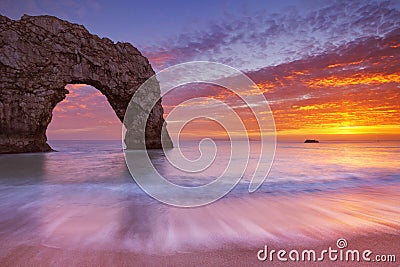 Durdle Door rock arch in Southern England at sunset Stock Photo