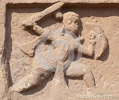 Durg, Chhattisgarh, India - January 18, 2009 Ancient stone bas relief of a warrior with a sword and a shield Editorial Stock Photo