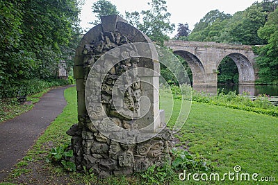 Durham, UK - 12 July, 2023: Stone Gargoyle Chair on the banks of the River Wear, Durham, England Stock Photo