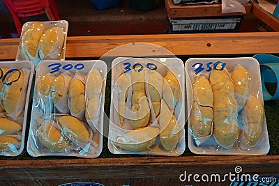Durian fruit in packages on sale in market, yellow durian in packaging as seasonal fruit of Thailand Editorial Stock Photo