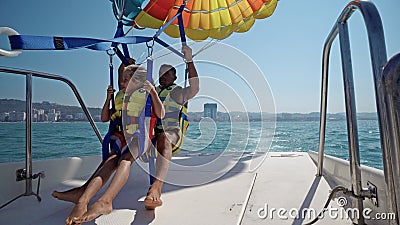 Tourists prepare for take off from boat at parasailing Editorial Stock Photo