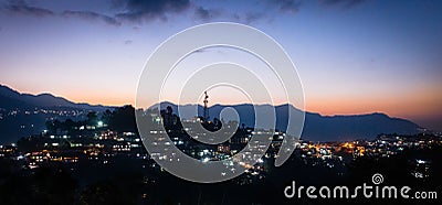 Dusk at a hillside city Stock Photo