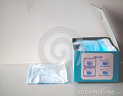 Dust mask to prevent air pollution with paper boxes on a white background Stock Photo