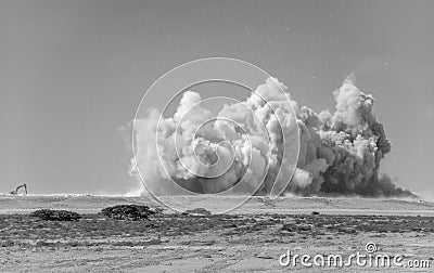 Dust storm in the Arabian desert due to detonator blast Stock Photo