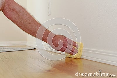 Dusting a Baseboard Stock Photo