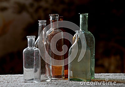 Dusty antique bottles in different colors Stock Photo