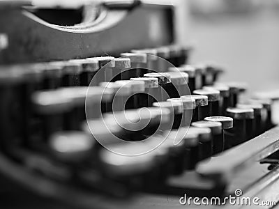 Dusty antique typewriter with focus on the keys in black and white Stock Photo