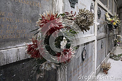 Dusty fake flowers on old grave stones Editorial Stock Photo