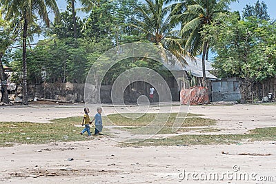 Dusty street view with two small boys in the fishing village of Nungwi. Zanzibar Editorial Stock Photo