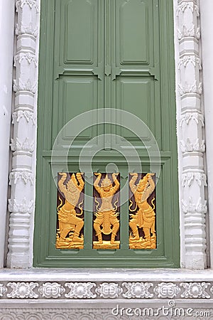 dusty white ancient building facade with beautiful green wooden windows and carving on wood decorated Stock Photo