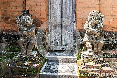 Stone figures as guards at family compound, Dusun Ambengan, Bali Indonesia Editorial Stock Photo