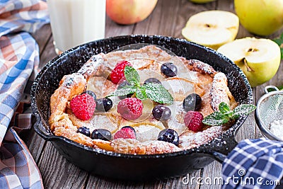 Dutch baby pancake with apple and cinnamon and fresh blueberry Stock Photo