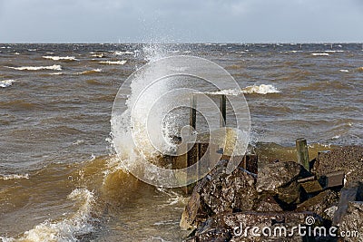 Dutch breakwater with breaking wave in heavy storm Stock Photo