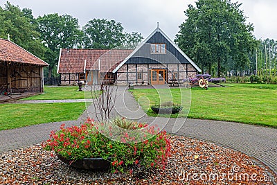 Dutch countryside with farmhouse and field with old agricultural machinery Stock Photo