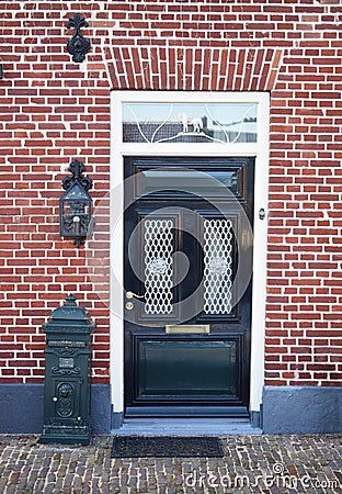 Dutch front door with mailbox and lantern. Brick house Stock Photo