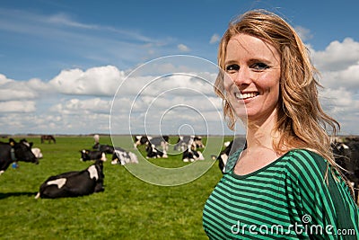 Dutch girl in field with cows Stock Photo