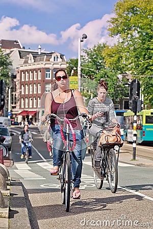 Dutch girl on her Bicycle, Amsterdam, netherlands. Editorial Stock Photo