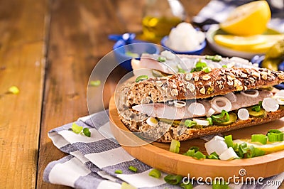 Dutch herring. Toast with Dutch herring, onions, pickles. Stock Photo