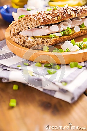 Dutch herring. Toast with Dutch herring, onions, pickles. Traditional rustic appetizer with seafood. Popular food in the Stock Photo