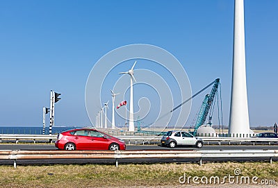 Dutch highway with cars along construction site wind turbines Stock Photo