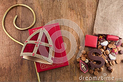 Dutch holiday Sinterklaas background with mitre or mijter staff and book of Sinterklaas. Stock Photo