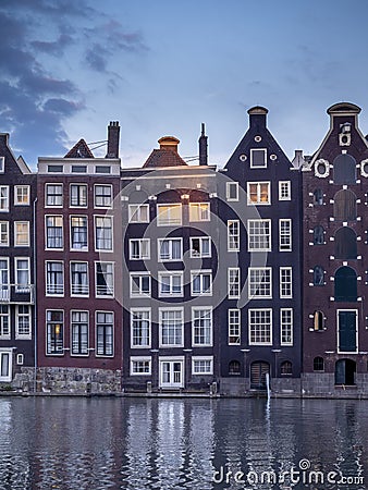 Dutch houses on the Damrak in Amsterdam. Stock Photo