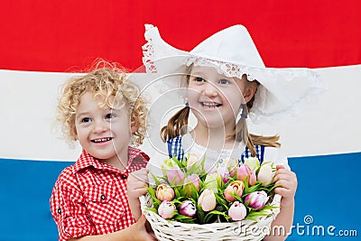 Dutch kids with tulip flowers and Netherlands flag Stock Photo