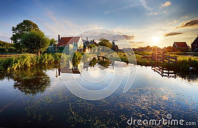 Dutch landscape with windmill at dramatic sunset, Zaandam, Amste Stock Photo