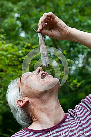 Dutch man is eating herring Stock Photo