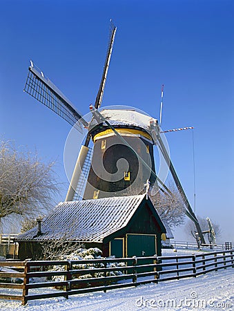 A Dutch mill in a winter landscape Stock Photo