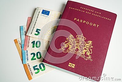 Dutch passport with Euros next to it Stock Photo