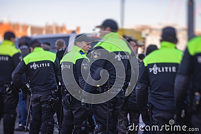 Dutch police squad formation and horseback riding mounted police back view with Editorial Stock Photo