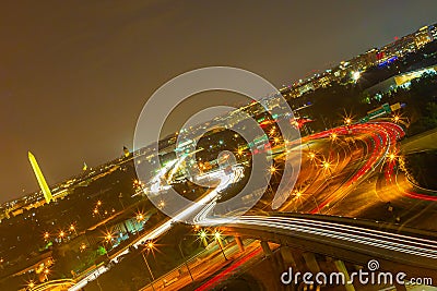 Dutch tilt Highway 395 with car lights trails. Washington DC Night photography aerial view. Washington Monument Stock Photo