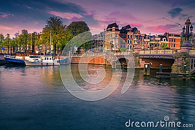 Dutch water canals with moored boats at sunset, Amsterdam, Netherlands Stock Photo