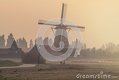 Dutch windmill on a foggy afternoon Stock Photo