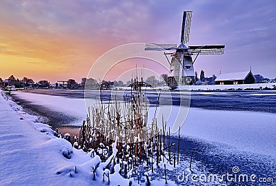Dutch windmill in the snow of a holland winter Stock Photo