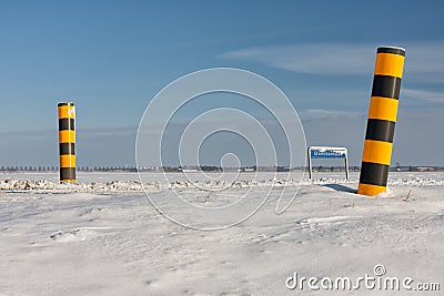 Dutch winter landscape with snowy farmland and colorful road signs Stock Photo