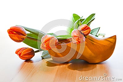 Dutch wooden shoe and orange tulips Stock Photo